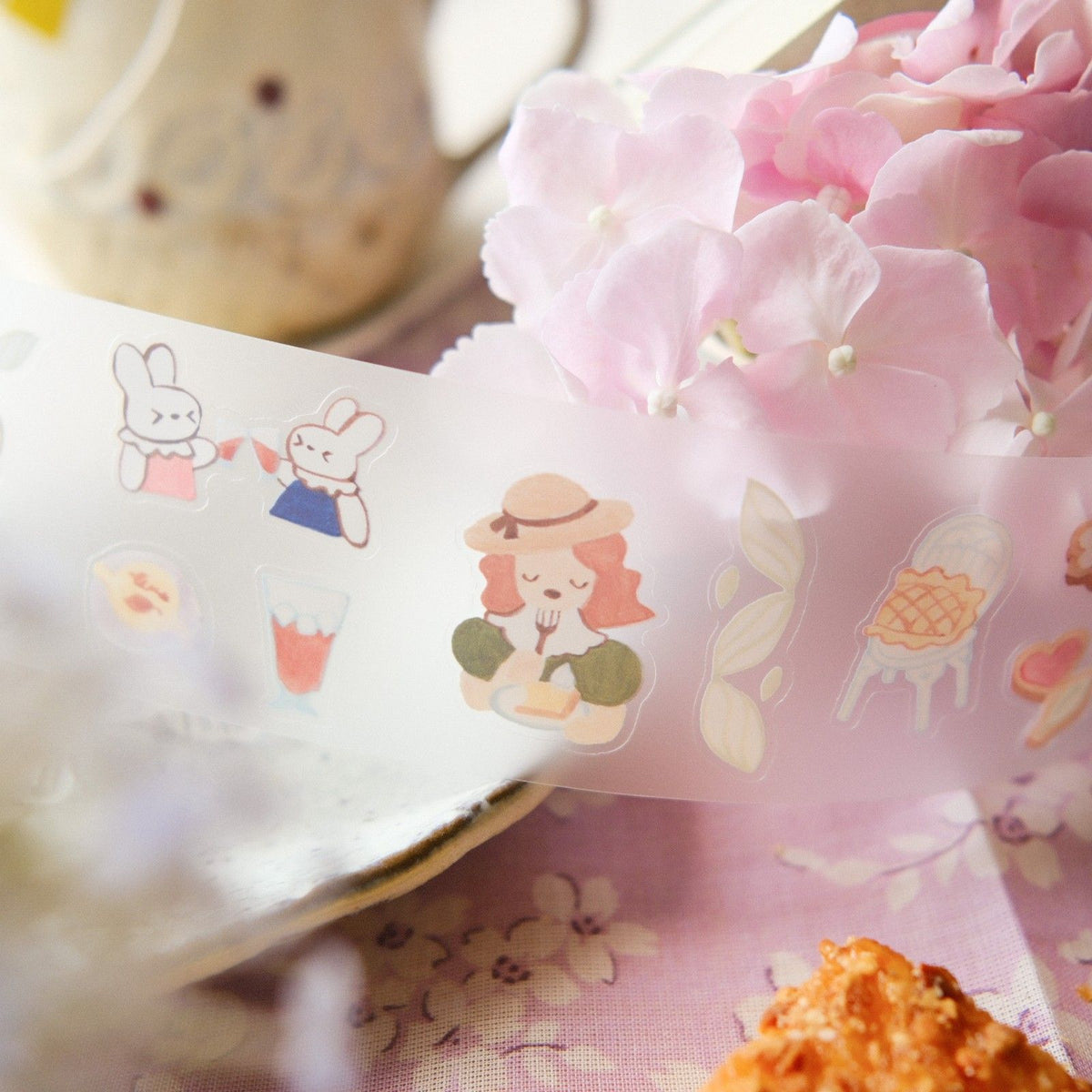 Sticker sheet with cute character designs on a pink floral background