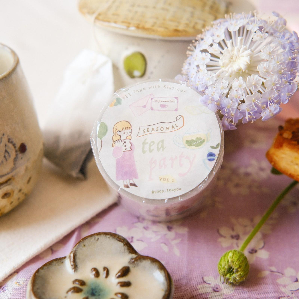 Jar of tea bags with decorative elements on a floral background