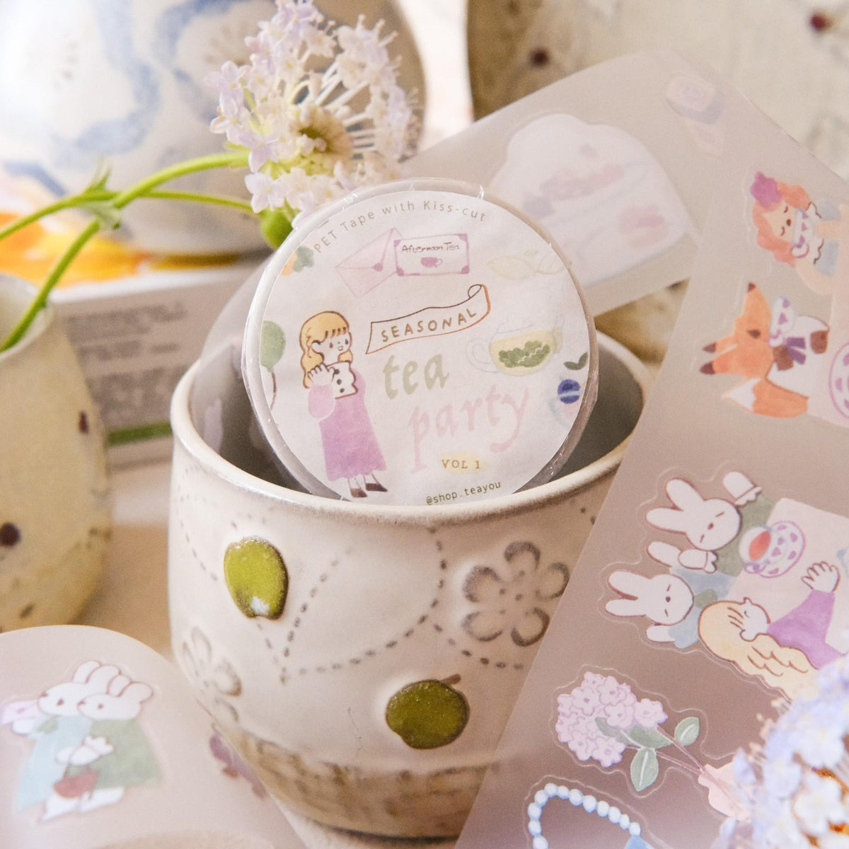Tea party-themed product with decorative elements on a soft background